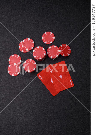 Playing cards and chips on a table, a gambling game of blackjack or baccarat. Cards and chips Playing cards and chips on a table, a gambling game of blackjack or baccarat. Cards and chips 139147757