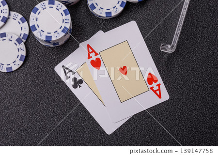 Playing cards and chips on a table, a gambling game of blackjack or baccarat. Cards and chips Playing cards and chips on a table, a gambling game of blackjack or baccarat. Cards and chips 139147758
