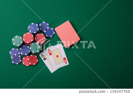 Playing cards and chips on a green cloth, a gambling game of blackjack or baccarat. Cards and chips 139147768