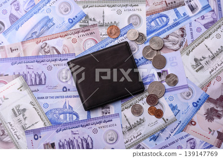 United Arab Emirates cash, dirhams and coins for exchange and financial transactions. UAE currency United Arab Emirates cash, dirhams and coins for exchange and financial transactions. UAE currency 139147769