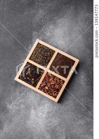 A box of various dry teas, black, green, herbal, and fruit. A set of different tea varieties A box of various dry teas, black, green, herbal, and fruit. A set of different tea varieties 139147773