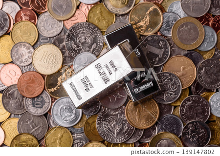 A silver bar, white metal against a backdrop of money, as a concept for the sales. A silver bar A silver bar, white metal against a backdrop of money, as a concept for the sales. A silver bar 139147802