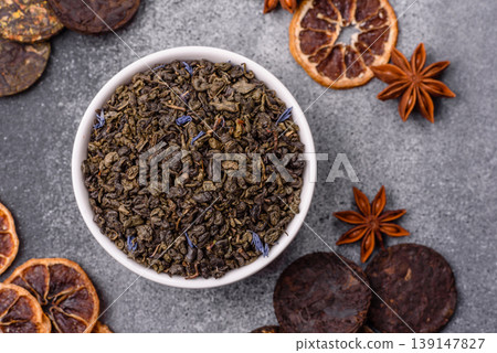 Granules of dried organic Chinese green tea with herbal additives. Dry green tea 139147827