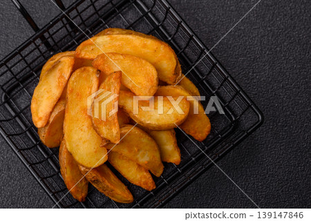 Potato wedges baked with garlic, herbs, and spices for lunch. Potato wedges Potato wedges baked with garlic, herbs, and spices for lunch. Potato wedges 139147846