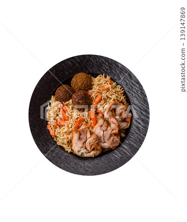 Kabsa or mandi, an Arabic dish with rice and chicken, salt, and spices. Kabsa or mandi Kabsa or mandi, an Arabic dish with rice and chicken, salt, and spices. Kabsa or mandi 139147869