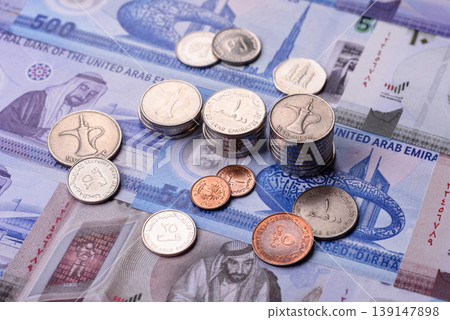 United Arab Emirates cash, dirhams and coins for exchange and financial transactions. UAE currency United Arab Emirates cash, dirhams and coins for exchange and financial transactions. UAE currency 139147898