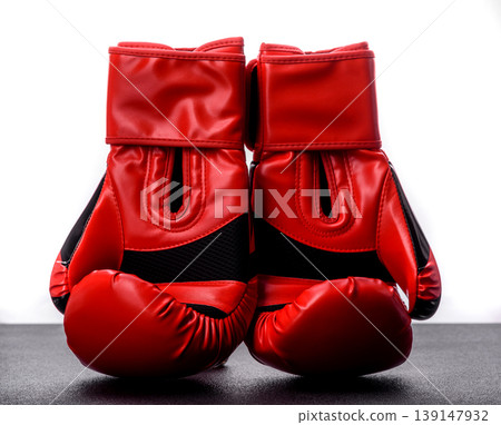 Two red boxing gloves for a fight, or as a symbol of overcoming illness. Red boxing gloves 139147932