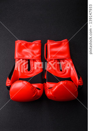 Two red boxing gloves for a fight, or as a symbol of overcoming illness. Red boxing gloves Two red boxing gloves for a fight, or as a symbol of overcoming illness. Red boxing gloves 139147933