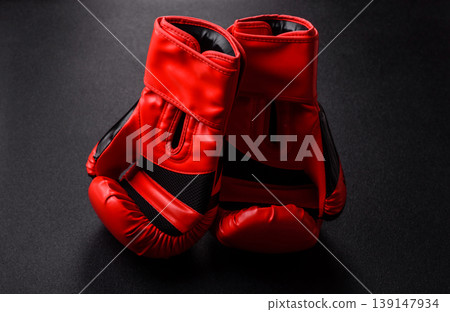 Two red boxing gloves for a fight, or as a symbol of overcoming illness. Red boxing gloves 139147934