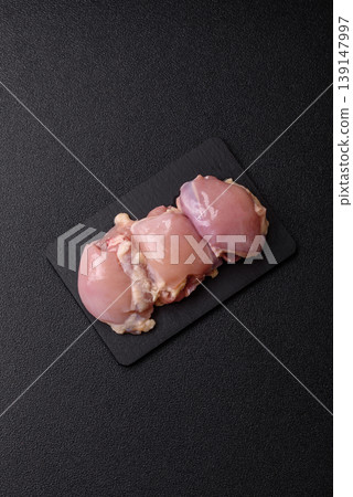 Raw chicken thigh fillet, boneless and skinless, for roasting. Raw thigh fillet 139147997