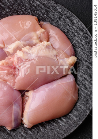Raw chicken thigh fillet, boneless and skinless, for roasting. Raw thigh fillet Raw chicken thigh fillet, boneless and skinless, for roasting. Raw thigh fillet 139148014