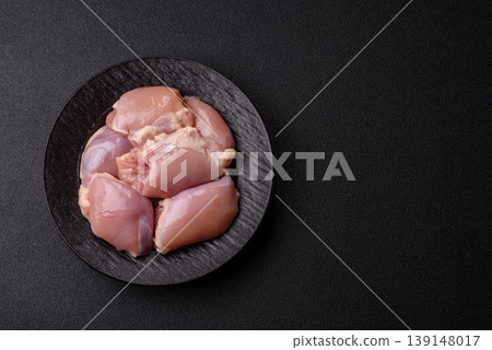 Raw chicken thigh fillet, boneless and skinless, for roasting. Raw thigh fillet Raw chicken thigh fillet, boneless and skinless, for roasting. Raw thigh fillet 139148017