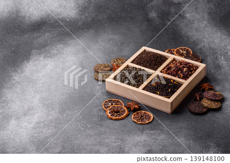 A box of various dry teas, black, green, herbal, and fruit. A set of different tea varieties A box of various dry teas, black, green, herbal, and fruit. A set of different tea varieties 139148100