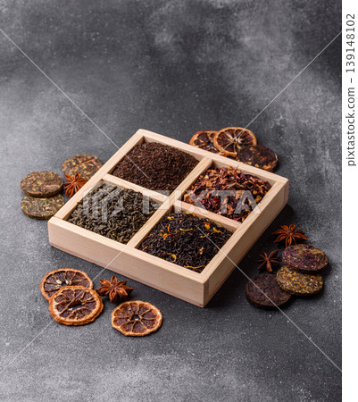 A box of various dry teas, black, green, herbal, and fruit. A set of different tea varieties A box of various dry teas, black, green, herbal, and fruit. A set of different tea varieties 139148102