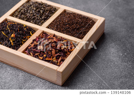 A box of various dry teas, black, green, herbal, and fruit. A set of different tea varieties A box of various dry teas, black, green, herbal, and fruit. A set of different tea varieties 139148106