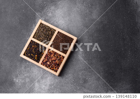 A box of various dry teas, black, green, herbal, and fruit. A set of different tea varieties A box of various dry teas, black, green, herbal, and fruit. A set of different tea varieties 139148110