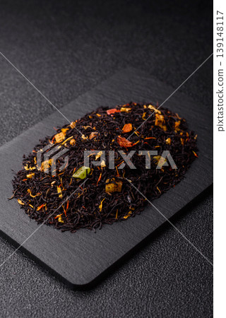 Dry black tea with herbal leaves and aromatic additives. Dry fruity black tea Dry black tea with herbal leaves and aromatic additives. Dry fruity black tea 139148117
