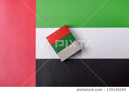 Cargo container on the uae flag as a conceptual backdrop for goods export. Cargo container Cargo container on the uae flag as a conceptual backdrop for goods export. Cargo container 139148260