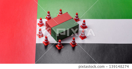 The cargo container ban on the uae flag as a conceptual backdrop. The cargo container embargo The cargo container ban on the uae flag as a conceptual backdrop. The cargo container embargo 139148274