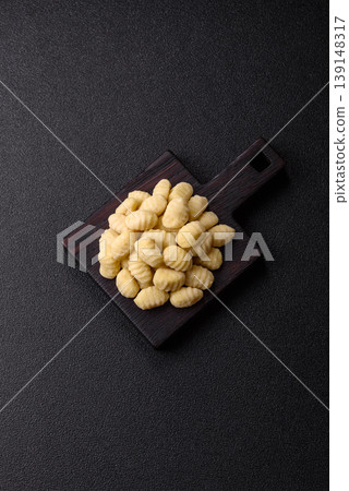 Raw homemade potato gnocchi, made with salt and spices, ready for lunch. Raw gnocchi Raw homemade potato gnocchi, made with salt and spices, ready for lunch. Raw gnocchi 139148317