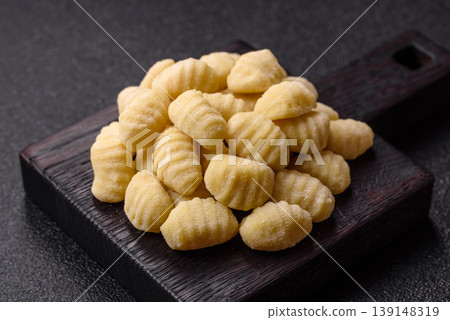 Raw homemade potato gnocchi, made with salt and spices, ready for lunch. Raw gnocchi Raw homemade potato gnocchi, made with salt and spices, ready for lunch. Raw gnocchi 139148319