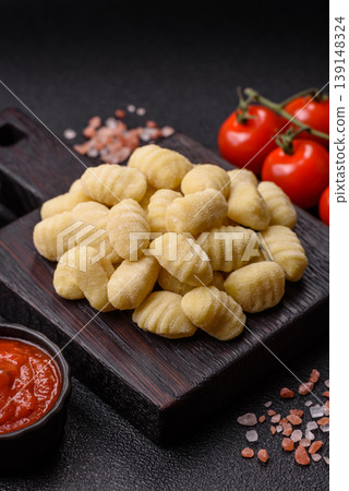 Raw homemade potato gnocchi, made with salt and spices, ready for lunch. Raw gnocchi Raw homemade potato gnocchi, made with salt and spices, ready for lunch. Raw gnocchi 139148324