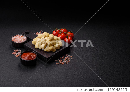 Raw homemade potato gnocchi, made with salt and spices, ready for lunch. Raw gnocchi Raw homemade potato gnocchi, made with salt and spices, ready for lunch. Raw gnocchi 139148325