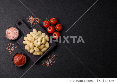 Raw homemade potato gnocchi, made with salt and spices, ready for lunch. Raw gnocchi Raw homemade potato gnocchi, made with salt and spices, ready for lunch. Raw gnocchi 139148326
