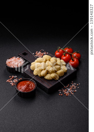 Raw homemade potato gnocchi, made with salt and spices, ready for lunch. Raw gnocchi Raw homemade potato gnocchi, made with salt and spices, ready for lunch. Raw gnocchi 139148327