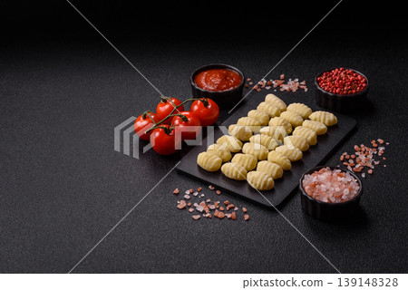 Raw homemade potato gnocchi, made with salt and spices, ready for lunch. Raw gnocchi Raw homemade potato gnocchi, made with salt and spices, ready for lunch. Raw gnocchi 139148328