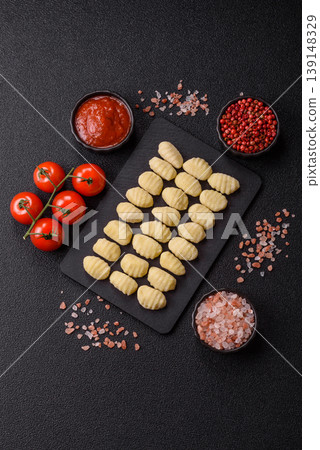 Raw homemade potato gnocchi, made with salt and spices, ready for lunch. Raw gnocchi Raw homemade potato gnocchi, made with salt and spices, ready for lunch. Raw gnocchi 139148329