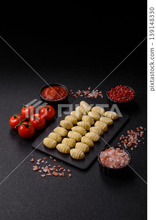 Raw homemade potato gnocchi, made with salt and spices, ready for lunch. Raw gnocchi Raw homemade potato gnocchi, made with salt and spices, ready for lunch. Raw gnocchi 139148330