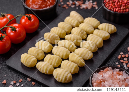 Raw homemade potato gnocchi, made with salt and spices, ready for lunch. Raw gnocchi Raw homemade potato gnocchi, made with salt and spices, ready for lunch. Raw gnocchi 139148331