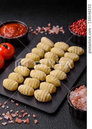 Raw homemade potato gnocchi, made with salt and spices, ready for lunch. Raw gnocchi Raw homemade potato gnocchi, made with salt and spices, ready for lunch. Raw gnocchi 139148333