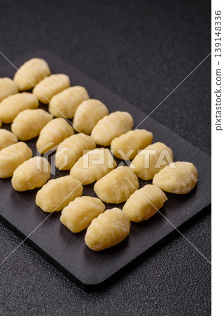 Raw homemade potato gnocchi, made with salt and spices, ready for lunch. Raw gnocchi Raw homemade potato gnocchi, made with salt and spices, ready for lunch. Raw gnocchi 139148336