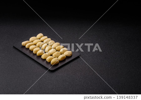Raw homemade potato gnocchi, made with salt and spices, ready for lunch. Raw gnocchi Raw homemade potato gnocchi, made with salt and spices, ready for lunch. Raw gnocchi 139148337
