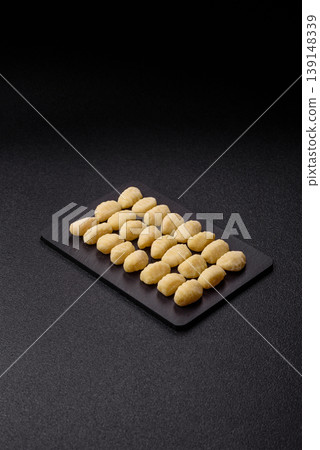 Raw homemade potato gnocchi, made with salt and spices, ready for lunch. Raw gnocchi Raw homemade potato gnocchi, made with salt and spices, ready for lunch. Raw gnocchi 139148339