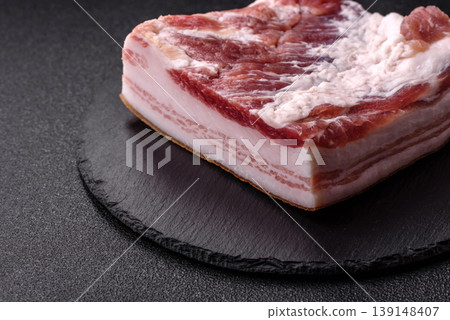 Raw fresh bacon slices with layers of meat or prosciutto prepared for frying. Raw bacon Raw fresh bacon slices with layers of meat or prosciutto prepared for frying. Raw bacon 139148407