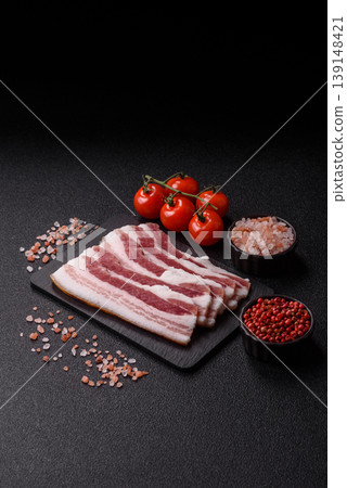 Raw fresh bacon slices with layers of meat or prosciutto prepared for frying. Raw bacon Raw fresh bacon slices with layers of meat or prosciutto prepared for frying. Raw bacon 139148421