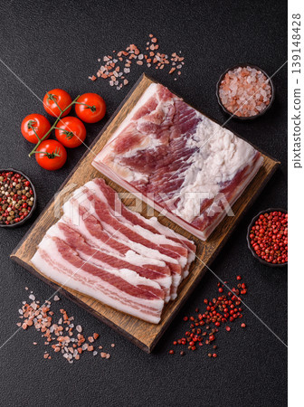 Raw fresh bacon slices with layers of meat or prosciutto prepared for frying. Raw bacon Raw fresh bacon slices with layers of meat or prosciutto prepared for frying. Raw bacon 139148428