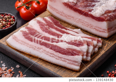 Raw fresh bacon slices with layers of meat or prosciutto prepared for frying. Raw bacon Raw fresh bacon slices with layers of meat or prosciutto prepared for frying. Raw bacon 139148430