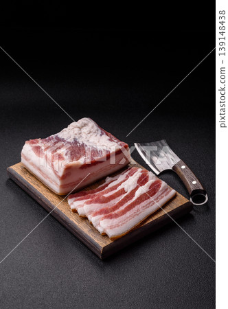 Raw fresh bacon slices with layers of meat or prosciutto prepared for frying. Raw bacon Raw fresh bacon slices with layers of meat or prosciutto prepared for frying. Raw bacon 139148438