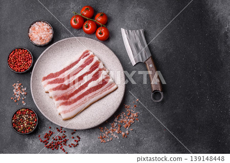 Raw fresh bacon slices with layers of meat or prosciutto prepared for frying. Raw bacon Raw fresh bacon slices with layers of meat or prosciutto prepared for frying. Raw bacon 139148448