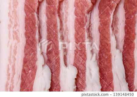 Raw fresh bacon slices with layers of meat or prosciutto prepared for frying. Raw bacon 139148450
