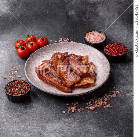 Fried fresh bacon slices with layers of meat or prosciutto prepared for breakfast. Fried bacon Fried fresh bacon slices with layers of meat or prosciutto prepared for breakfast. Fried bacon 139148453