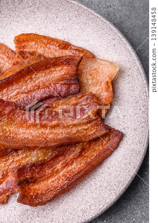 Fried fresh bacon slices with layers of meat or prosciutto prepared for breakfast. Fried bacon 139148458