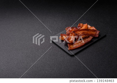 Fried fresh bacon slices with layers of meat or prosciutto prepared for breakfast. Fried bacon Fried fresh bacon slices with layers of meat or prosciutto prepared for breakfast. Fried bacon 139148463