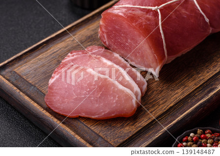 Smoked or dry cured meat slices, pork or ham with salt and spices. Smoked meat slices Smoked or dry cured meat slices, pork or ham with salt and spices. Smoked meat slices 139148487