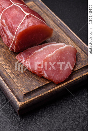 Smoked or dry cured meat slices, pork or ham with salt and spices. Smoked meat slices 139148492