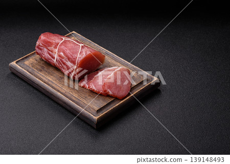 Smoked or dry cured meat slices, pork or ham with salt and spices. Smoked meat slices Smoked or dry cured meat slices, pork or ham with salt and spices. Smoked meat slices 139148493